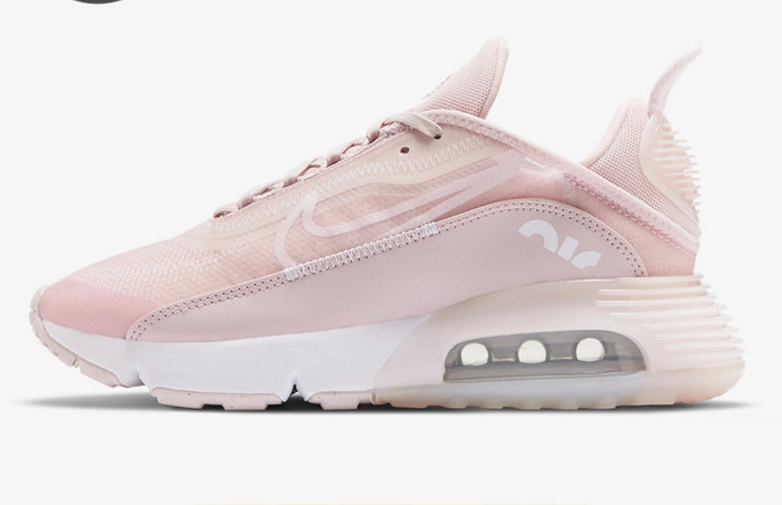 A pair of pink Nike Airmax 2090 sneakers with a visible Air cushioning unit and a mesh upper.